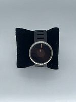 Front view showing stainless case, dark dial with two aperture discs, integrated vented strap