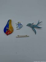 Group shot: Murano pendant, two enamel fish pieces, gold-tone bar brooch