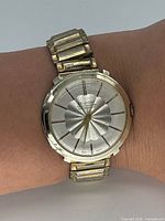 Front view of watch on wrist showing dial, bezel and bracelet