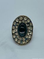 Front view showing shield face, cabochon, bead granulation and patina
