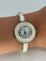 Front view of watch on wrist showing dial, bezel and cuff