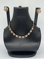 Full view of necklace on bust with earrings displayed