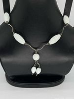 Necklace on display form showing front with drop