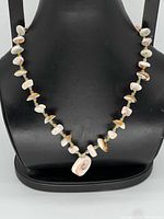 Front view of necklace on bust showing pendant and bead pattern