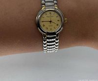 Full view of watch on wrist showing dial, case and bracelet