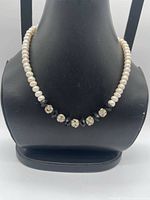 Necklace on bust showing pearl strand, rhinestone beads and black crystal spacers
