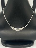 Front view of silver-tone rhinestone necklace on display bust