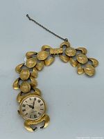 Front view showing dial, bracelet design and safety chain