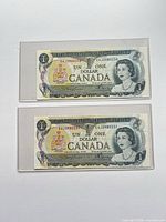 Fronts of both consecutive Canadian $1 bills showing serial numbers and Queen Elizabeth II portrait