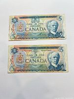Fronts of both 1979 $5 notes showing portrait, serial numbers, coat of arms