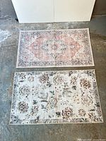 Both rugs laid out flat showing full designs and size comparison