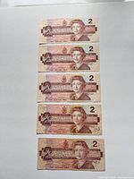 Obverse of five $2 Canadian notes