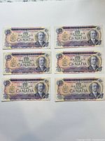 Obverse sides of six 1971 Canadian $10 bills showing portrait and colour