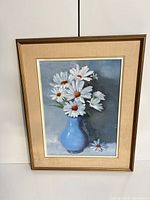 Front view of framed painting showing daisies in vase