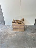 Stack of six wooden bench brackets showing X-brace design