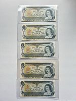 Five sequential Canadian one-dollar notes in sleeves