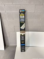 Full view of boxed Peak Gutter Guard showing branding and size