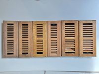 Front view of six oak furnace covers aligned vertically