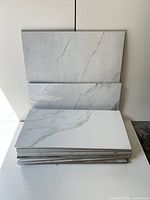stack of marble-look tiles showing veining and edges