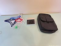 Overview showing LED emblem, boxed wallet, leather sling bag