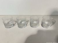 Front view of four Iittala Ultima Thule glass tumblers
