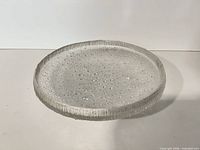 Top view of round clear textured glass serving tray