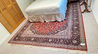Full view of rug under bed showing overall pattern and size