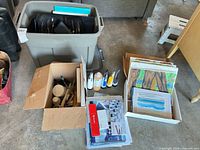 Overall lot with tote, boxes, paints, canvases, small paintings