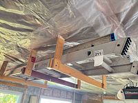 Ladder resting on wooden ceiling rack