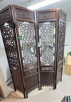Full view of four-panel carved wood folding screen