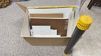 Box containing assorted boards, poster tube attached