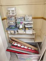 Full closet view with stacked storage bins and tote of wrapping paper