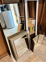 Group view showing large frameless and white-frame full-length mirrors plus smaller framed mirrors