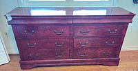 Front view of cherry veneer dresser showing six drawers and metal pulls