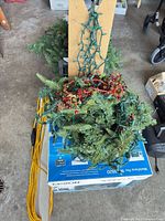 Garland, lights, beaded strand and extension cord atop box