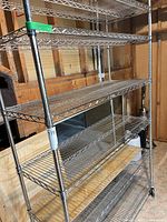 Full front view of six-shelf chrome wire unit on casters