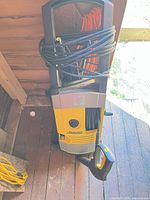 Full view of Kärcher pressure washer with hose and wand