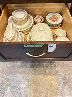 Drawer view of stacked plates, covered dish, fruit plates