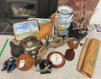 overview of all items including bird, clock, cookware, trays, canisters, vase and burlap