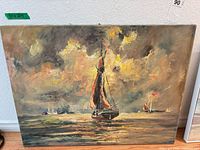 Front view of unframed oil on canvas seascape with central sailboat, artist signature visible