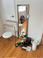 Group shot showing mirror, towel rack, stool, tabletop mirror and assorted accessories on floor