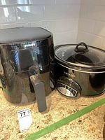 Philips air fryer beside Crock-Pot slow cooker, front view