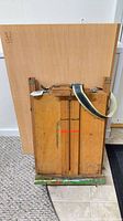Rear view of folded Conté à Paris box easel standing upright with detachable panel behind