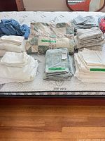 All bedding stacks on mattress showing variety and quantity