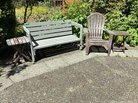 Group shot showing bench, Adirondack chair, and two folding tables