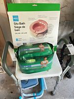 Shower chair seat holding sealed Depend pack and boxed Atoma sitz bath