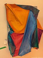 Front view of entire mixed-media canvas sculpture showing overall shape and colors