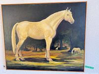 Full view of framed oil painting depicting cream-colored horse