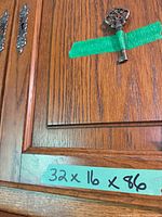 Close-up of door panel, key and hardware with taped dimensions