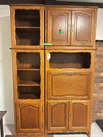 Full view of solid oak wall unit with shelves, drop-down desk, and cabinets